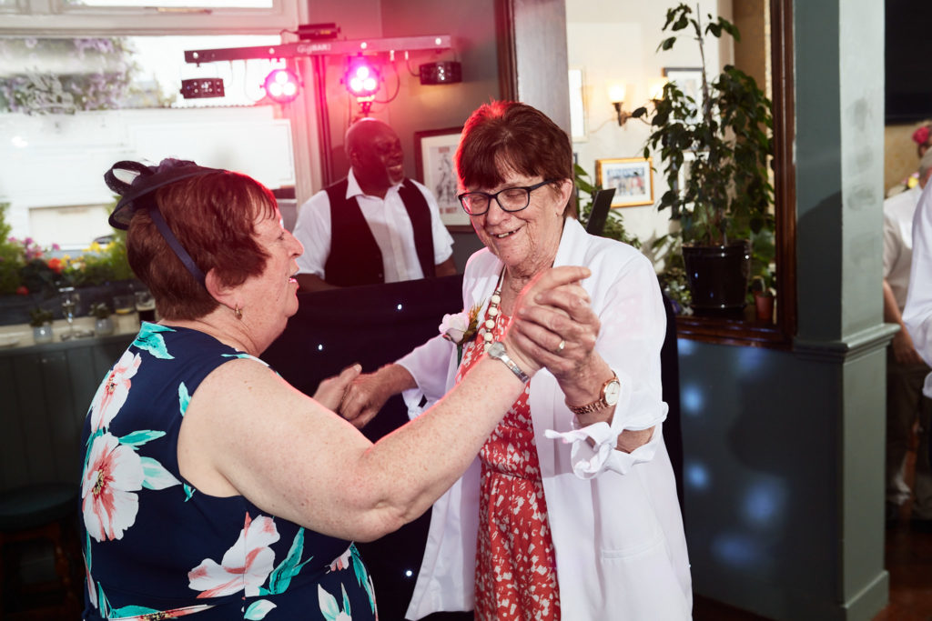 Two guests dancing together at the evening reception
