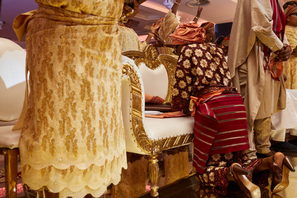 Guests kneeling in greeting during the traditional wedding ceremony