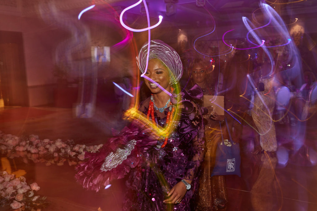 Bride dancing among swirls of neon light