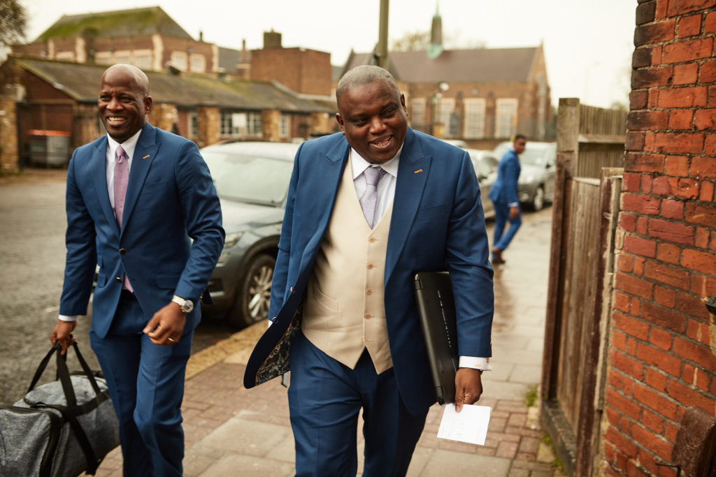 Groom and a groomsman arriving at the church