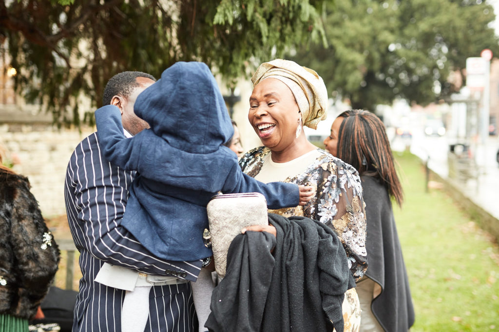 Wedding guests hugging outside the church