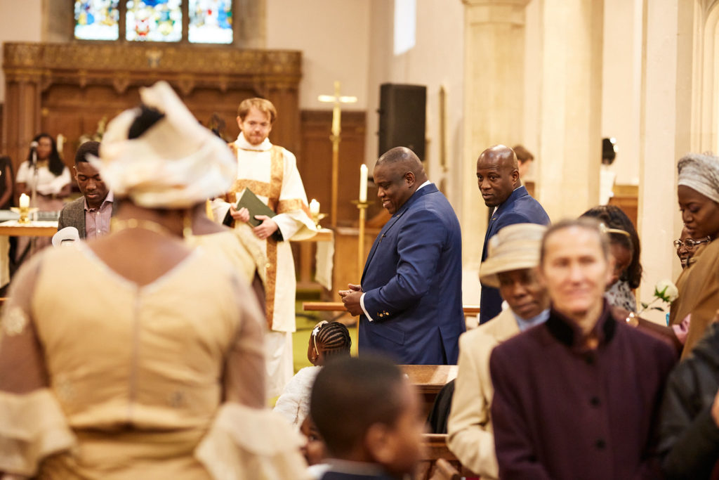 Guests standing as the bridal party enters the church