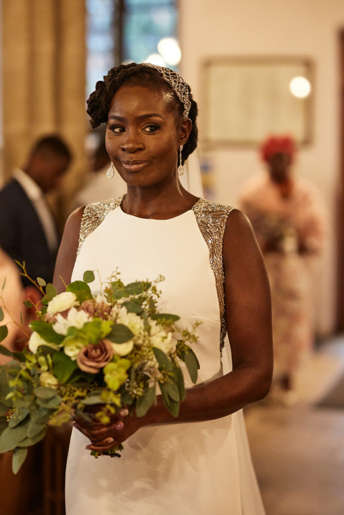 Bride holding her bouquet as she walks down the aisle
