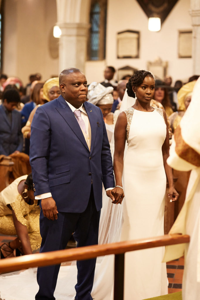 Bride and groom standing side by side at the front of the church