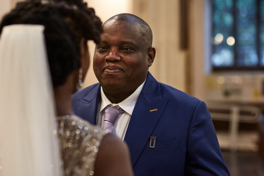 Groom smiling at the bride during their vows