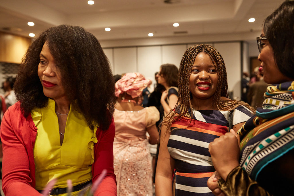 Wedding guests laughing together at the reception