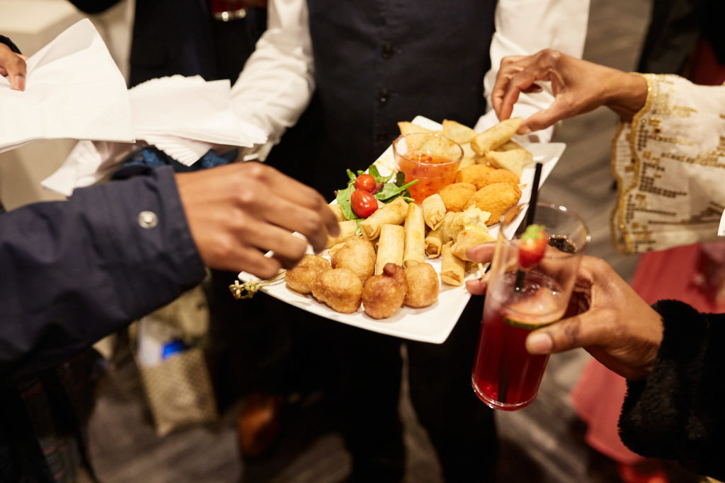 Guests helping themselves to canapés from a tray