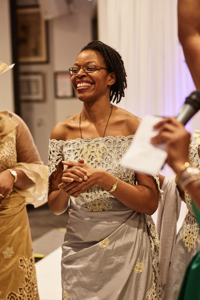 Wedding guest laughing as a microphone is held out to her