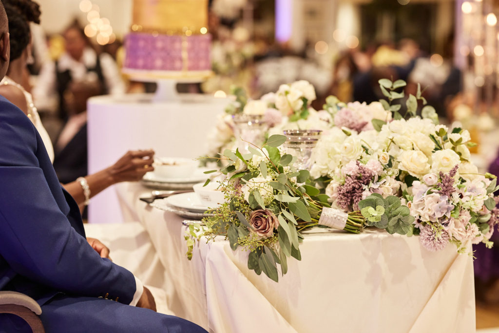 Top table decorated with white and lilac flowers