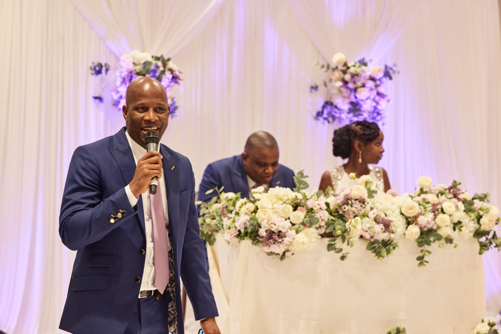 Groomsman giving a speech in front of the top table