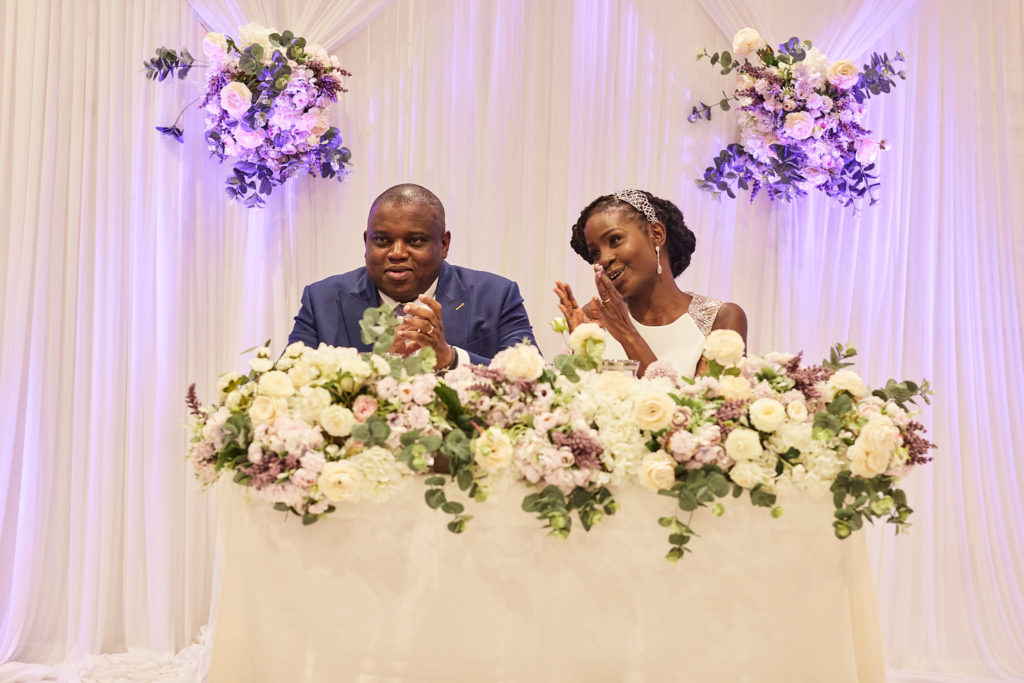 Bride and groom laughing at the top table during the speeches