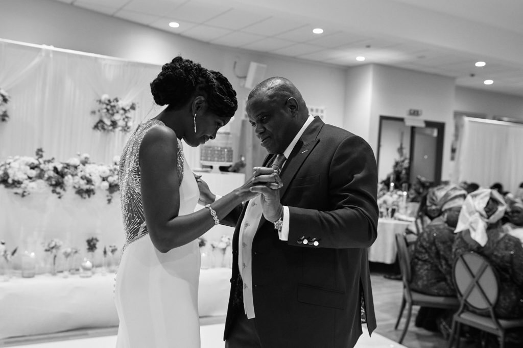 Black and white photo of the bride and groom dancing together