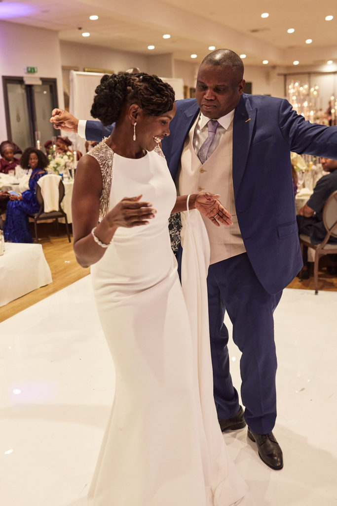 Bride and groom laughing as they dance