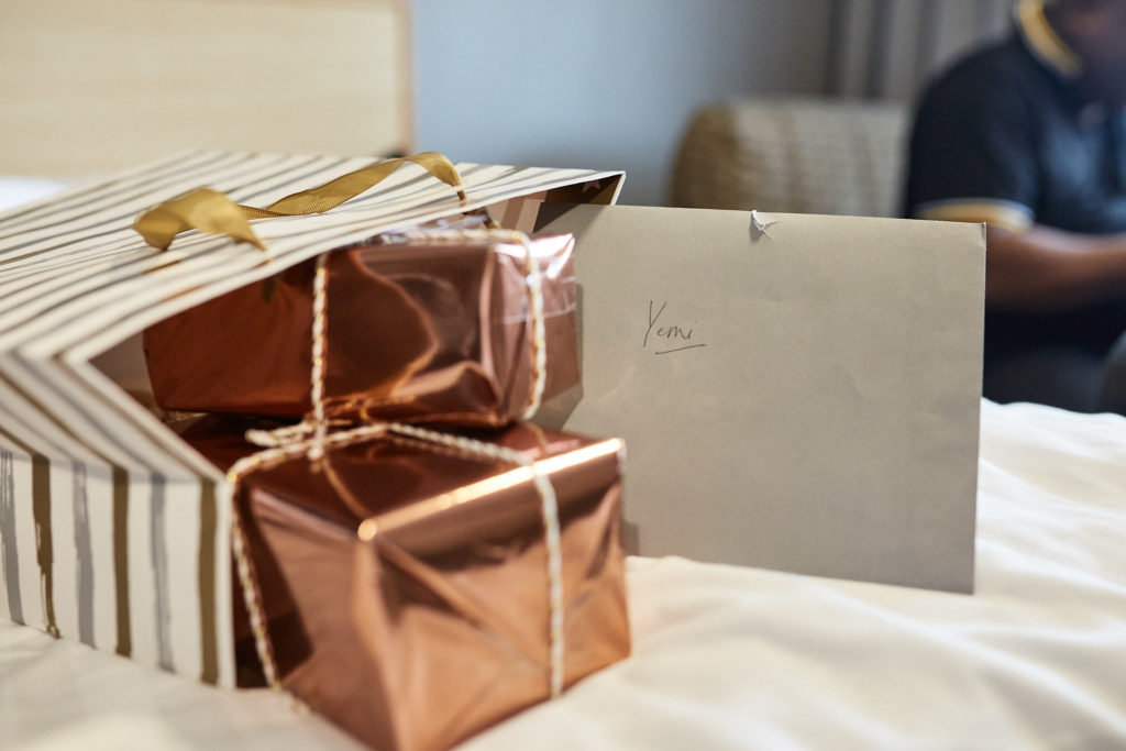 Wrapped wedding gifts on a bed
