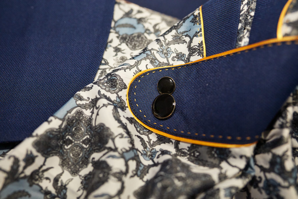 Close-up of a navy jacket cuff against a floral lining
